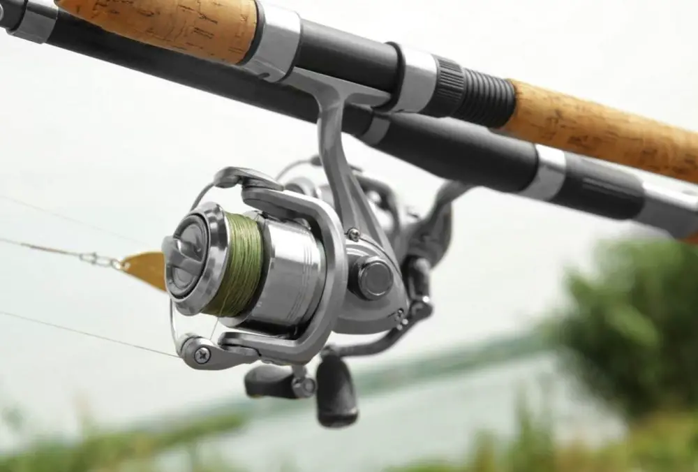 A spinning reel on a rod near the water