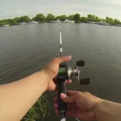 Pro fisherman fishing with a baitcaster in a lake