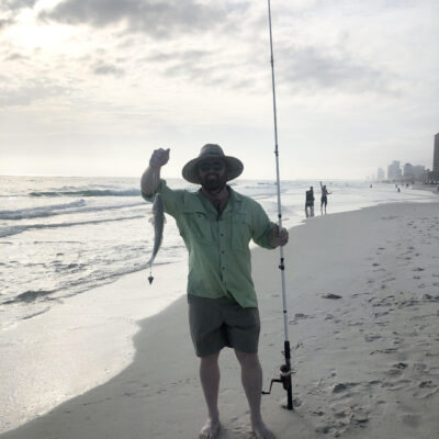 donny karr holding a redfish caught from the beach