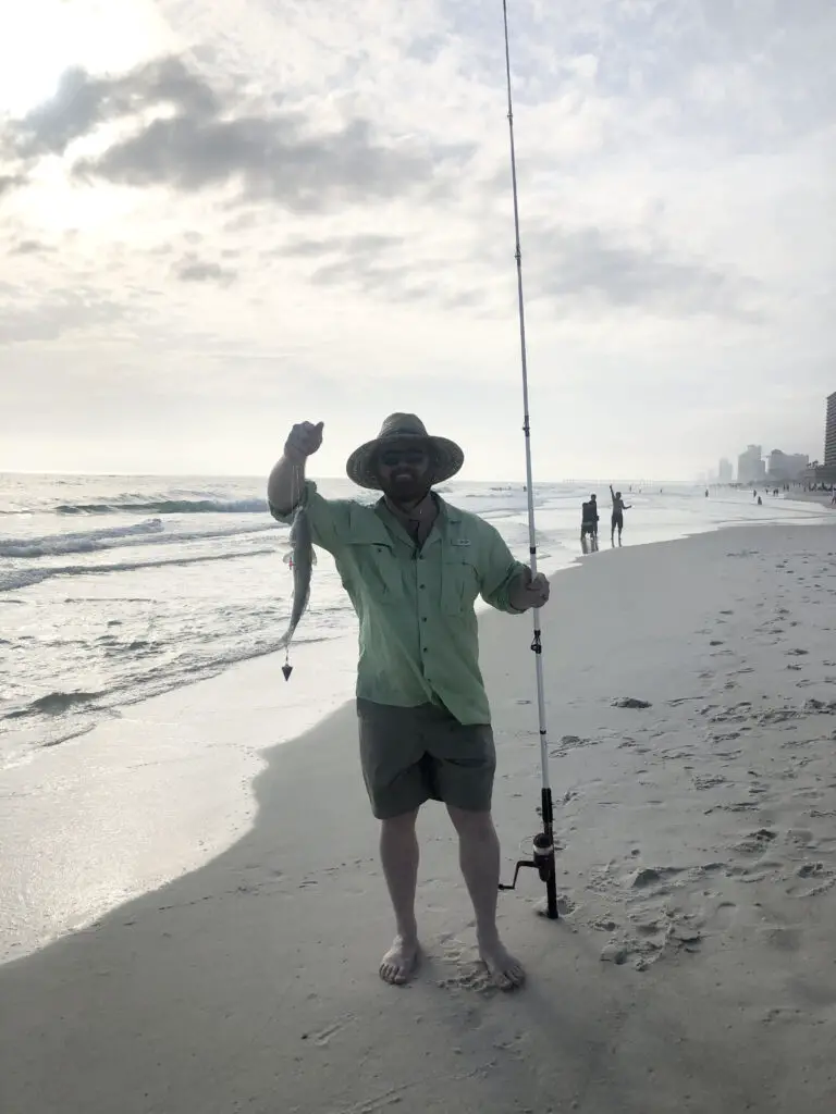 donny karr holding a redfish caught from the beach