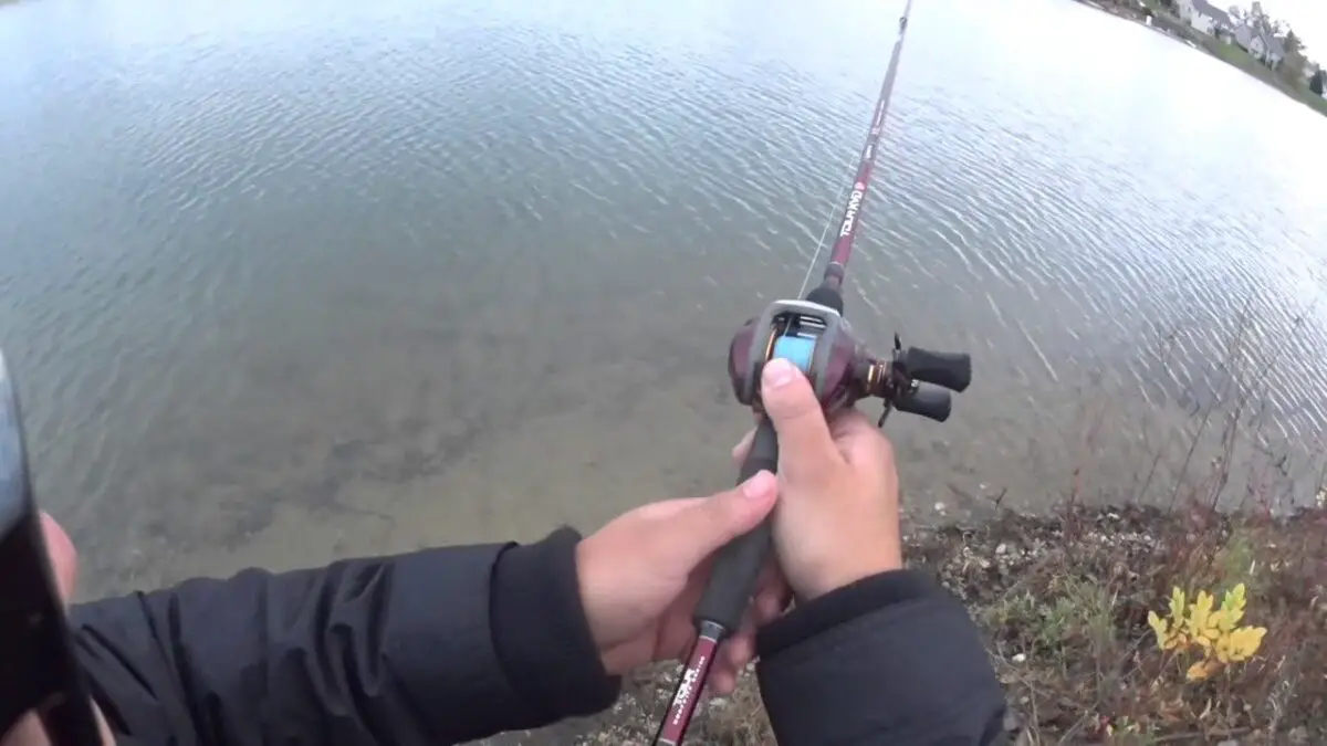 casting a baitcaster reel into a lake