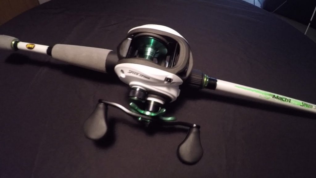 lews mach 1 baitcaster reel on rod laid flat