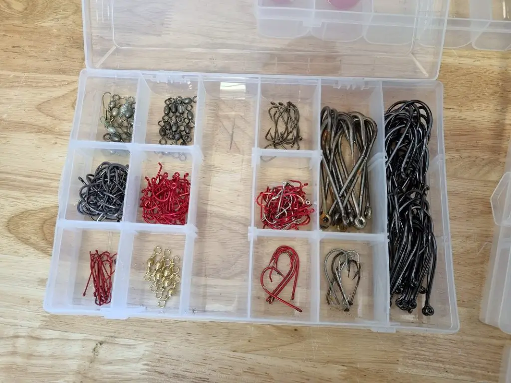 Russ showing his personal collection of fishing hook sizes inside a tackle tray