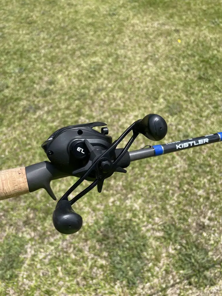 Kistler series 2 baitcasting reel attached to a reel with a grass background
