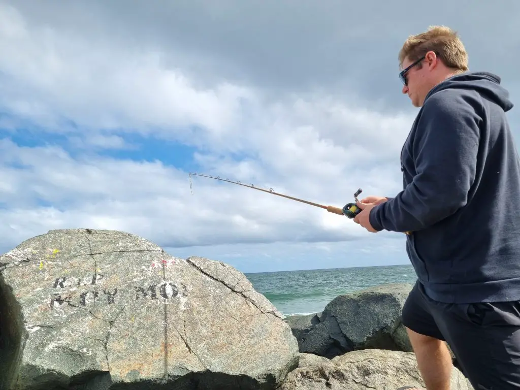 Shimano Curado is use by Russ Egan fishing with a lure in the ocean from the shore