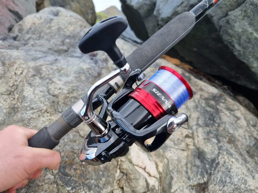 Shimano Sienna in use on the water focused on the reel